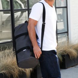 grey duffel standing